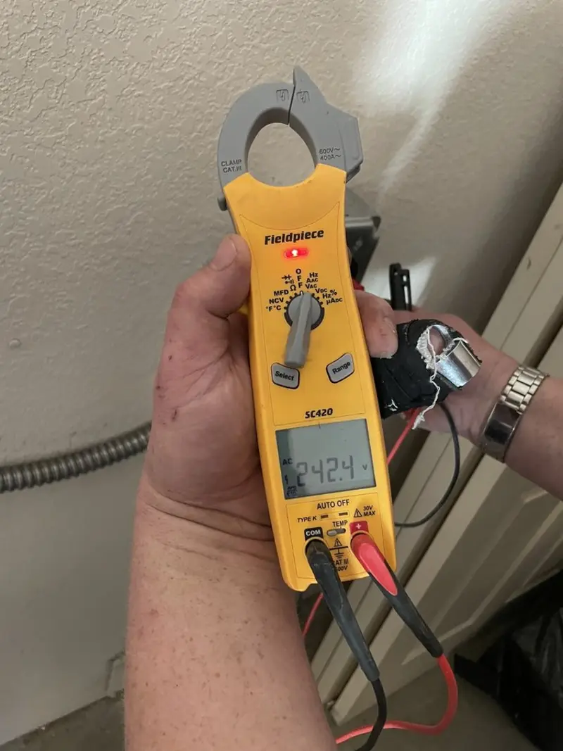 Voltage testing with clamp meter during Outlet Installation in College Station